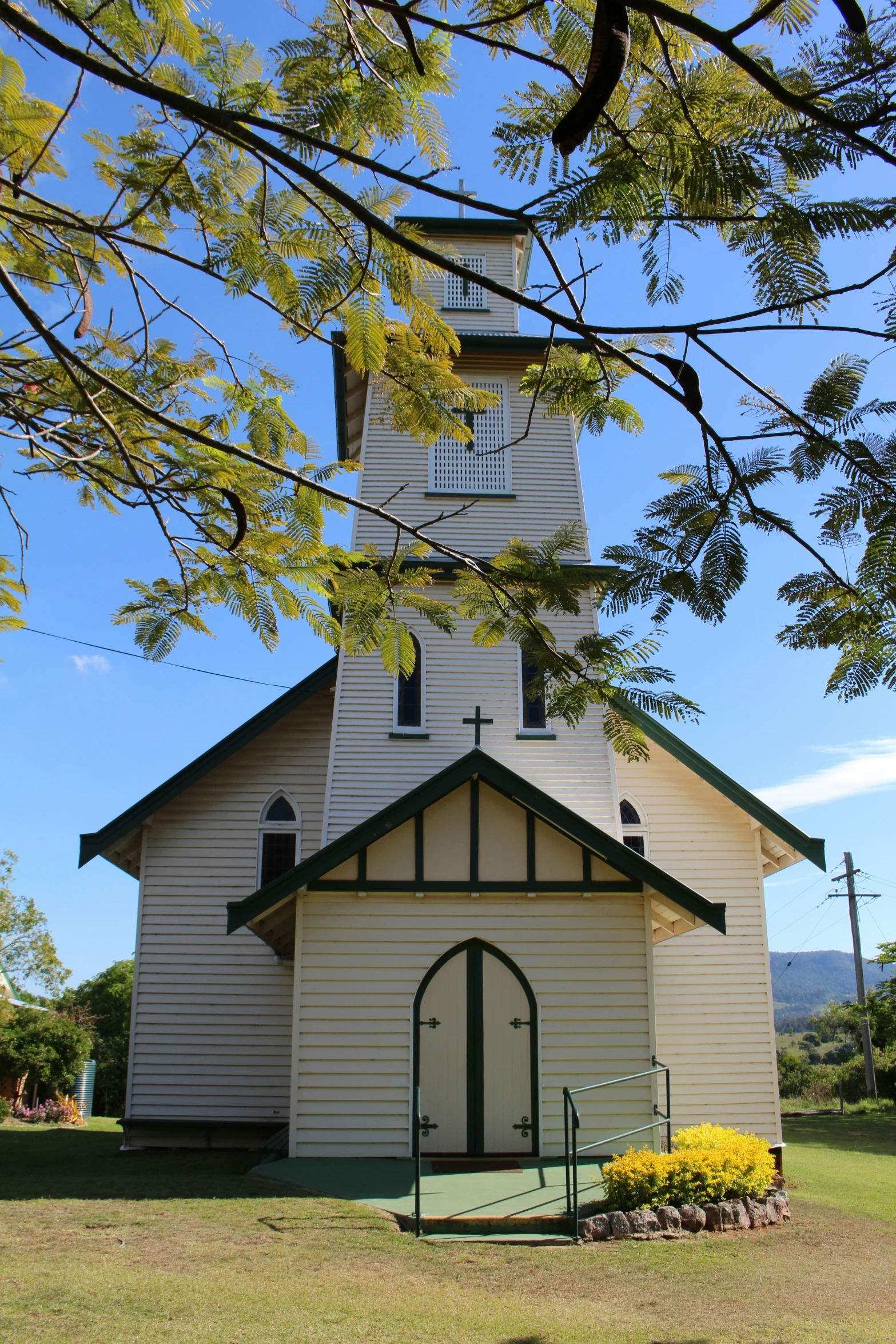 a small church has a steeple and a flag