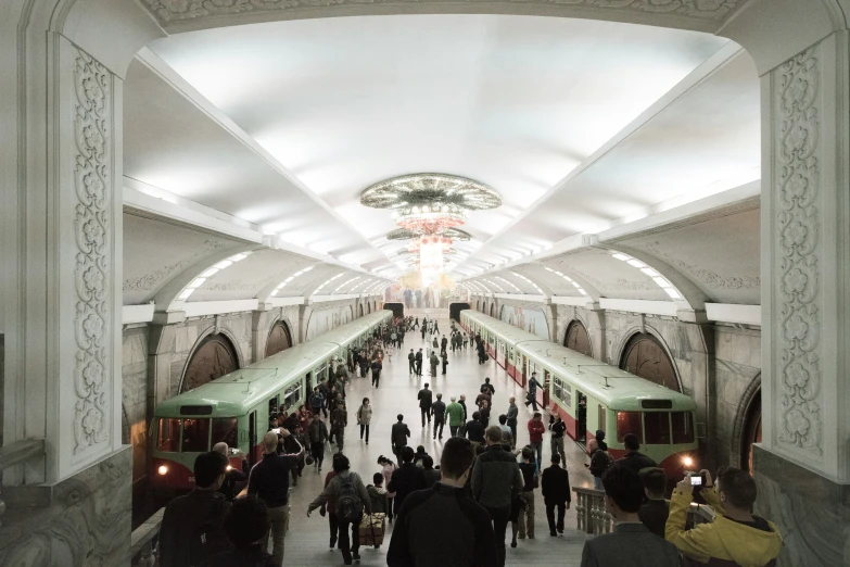 a group of people are standing in a train station