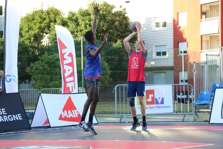 two men jump for a basketball in a competition