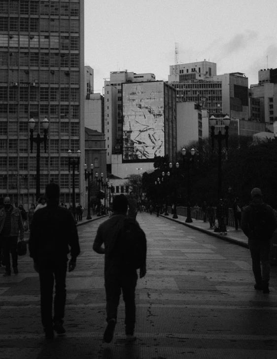 some people walking in the dark on a rainy day