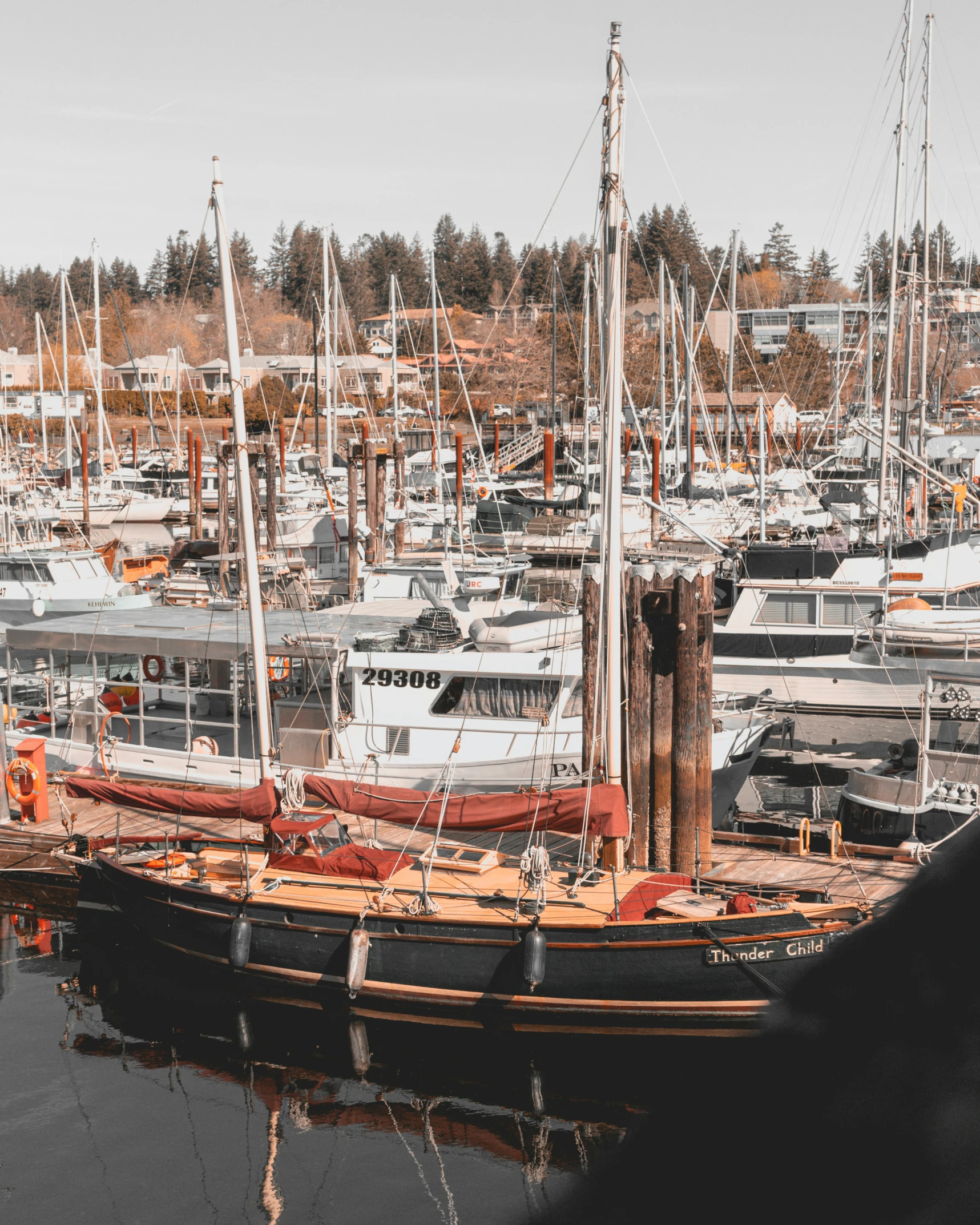 an old sailing boat sitting docked next to another boat