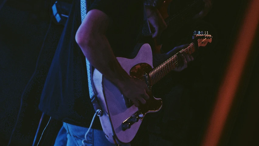 a man is holding a guitar in his hands