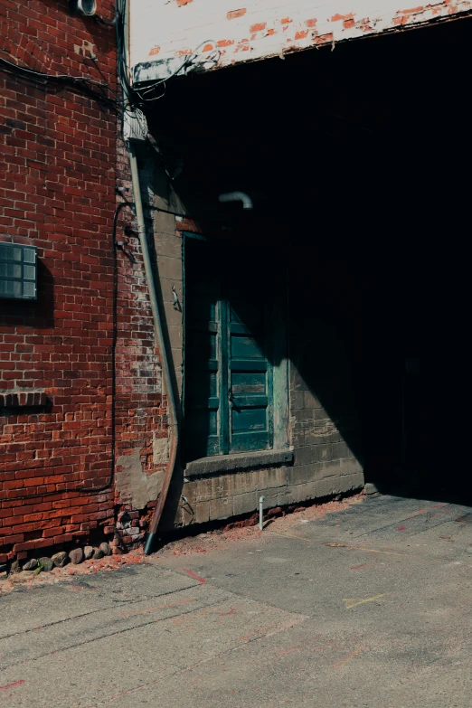 an old brick building is on an empty road