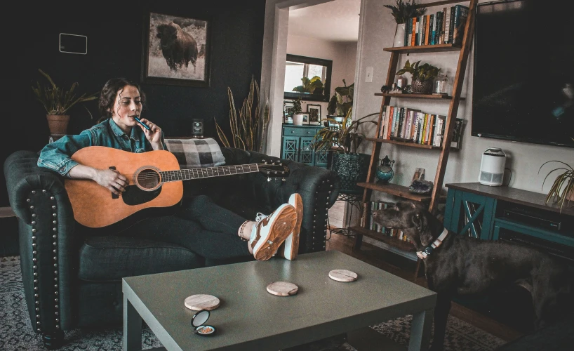 a man sitting in a chair with a guitar