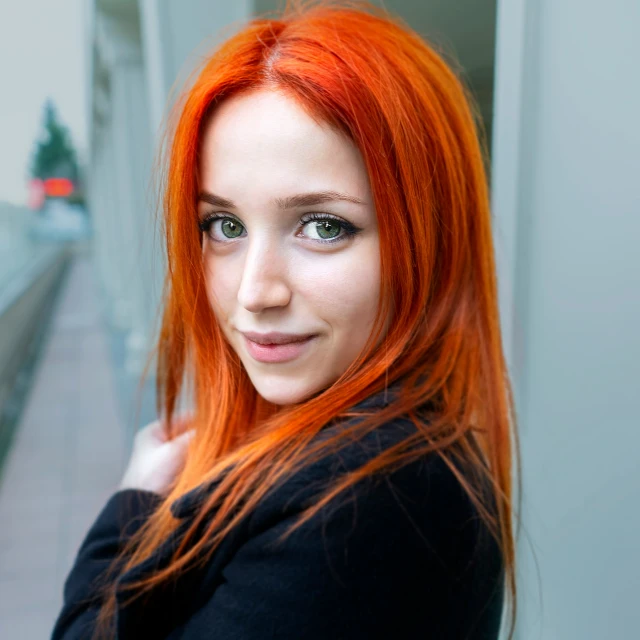 an orange haired girl with bright eyes and freckles