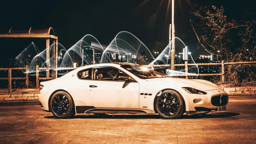 a masera is shown at night with water lights behind it