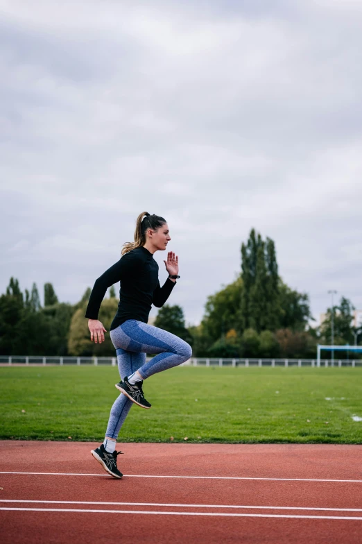 a woman running on a field, in a tight and tight outfit