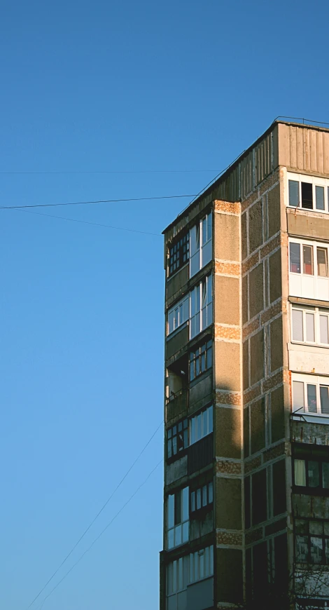 the top of an old building with power lines in the background