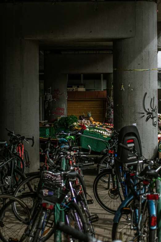 many bicycles are parked next to each other in a parking garage