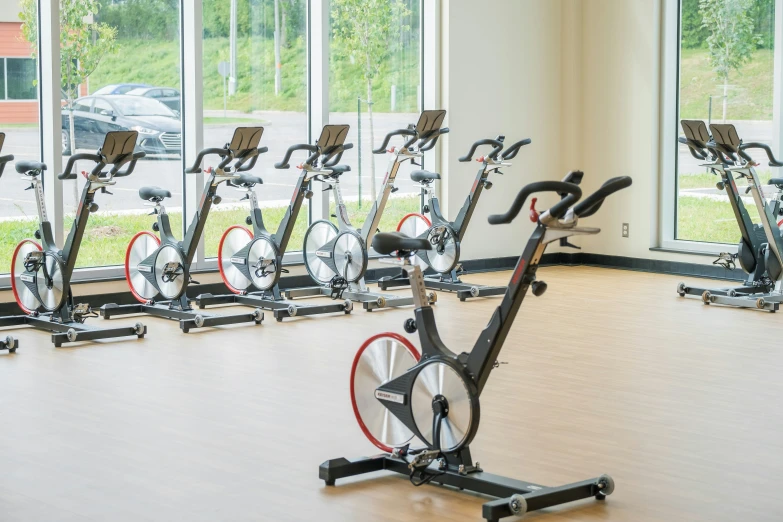 an indoor gym with many exercise bikes