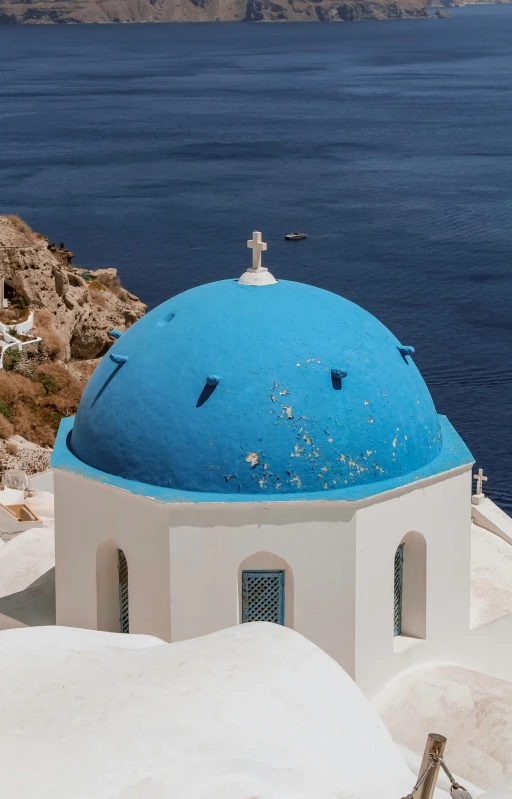 a small church by the sea on a hillside