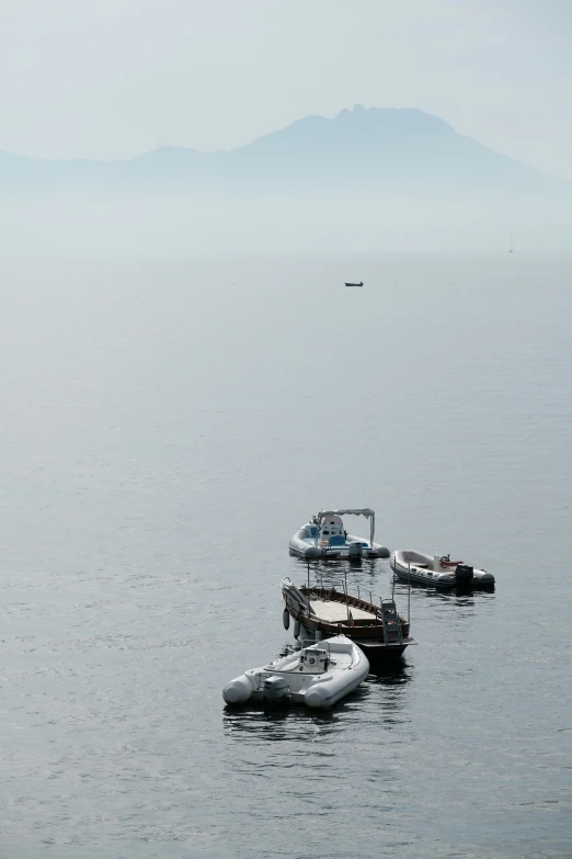 several small boats are docked in the ocean