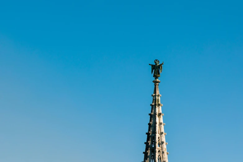 a very tall clock tower under a blue sky