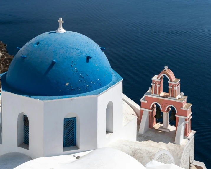 the dome of an old building next to the ocean