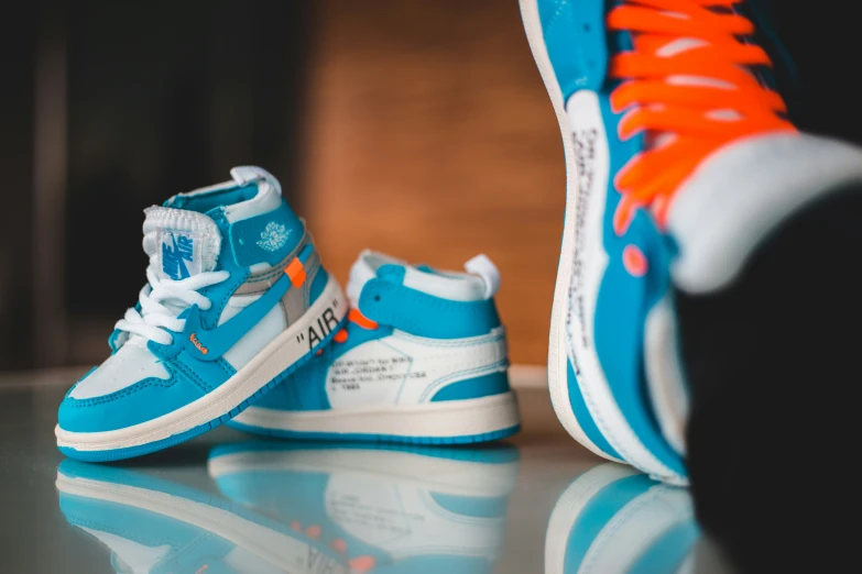 a blue and white sneaker and its reflection