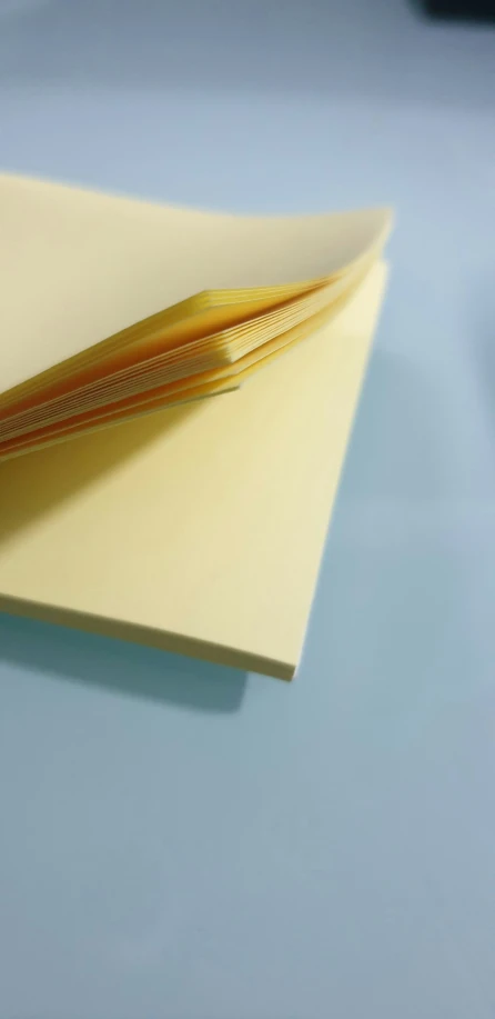 the cover is folded in a notepad and gold colored pen