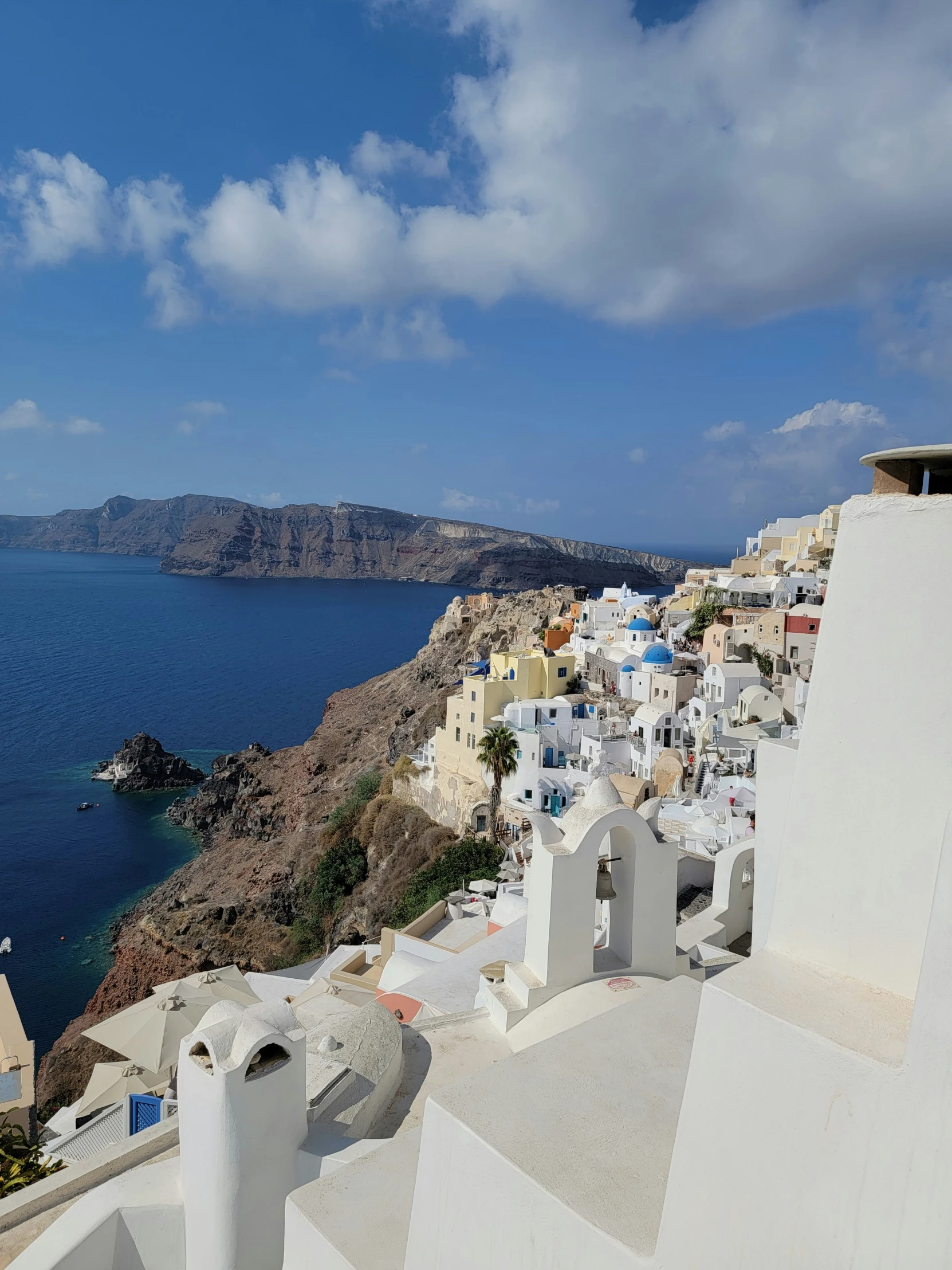 the view from a balcony of houses and the sea