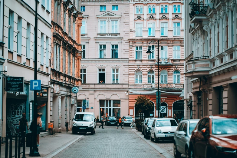 a street lined with tall buildings and cars parked on it