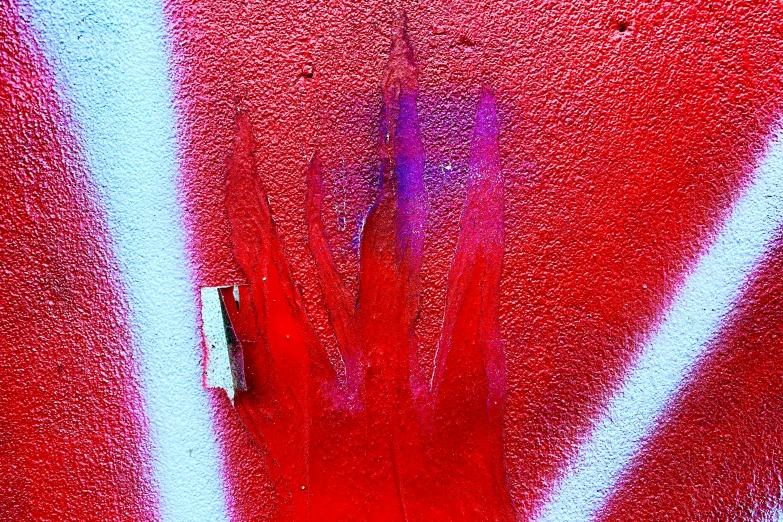 a close up of a red surface with the light from a window in front