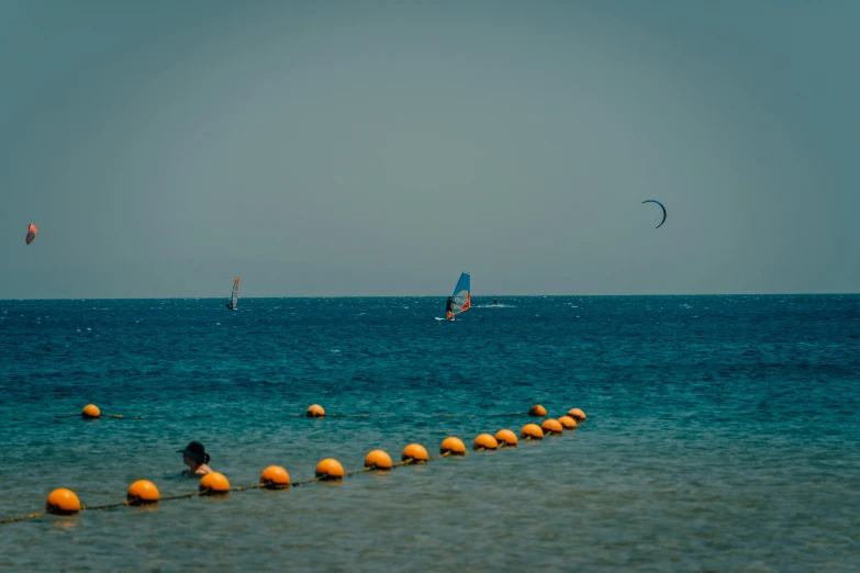 people wind surfing and water skiing on a clear day