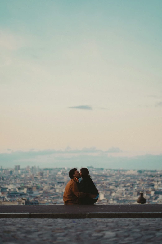 a couple of people sitting on top of a roof