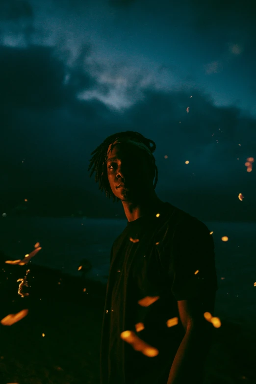 a man is standing in front of a fire