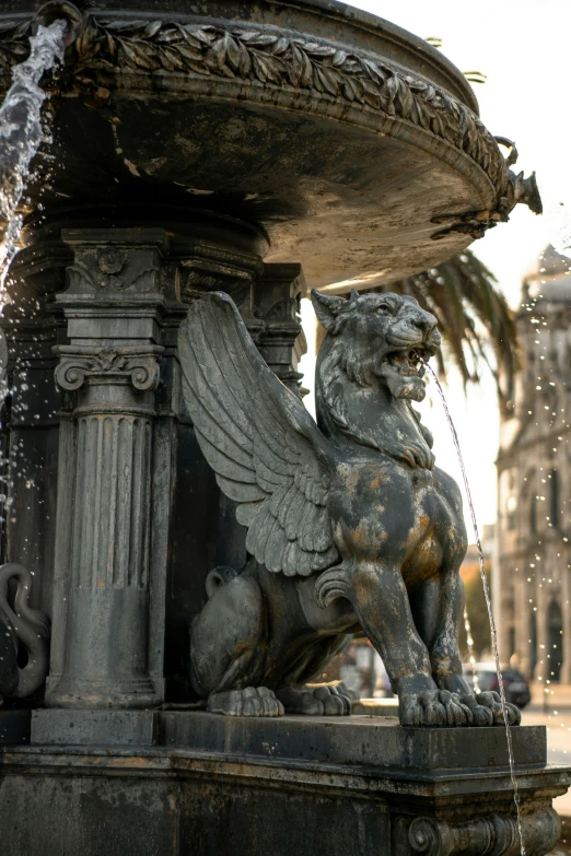 the statue is in front of the fountain