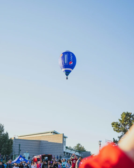 a person is in the air looking up at a  air balloon