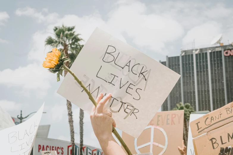 a man holding flowers with signs and posters