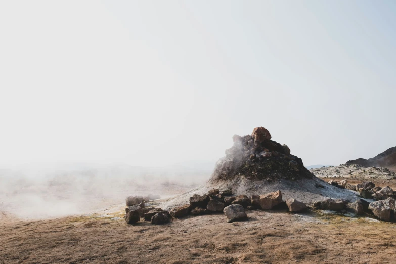 several pieces of stone piled up in the middle of a field