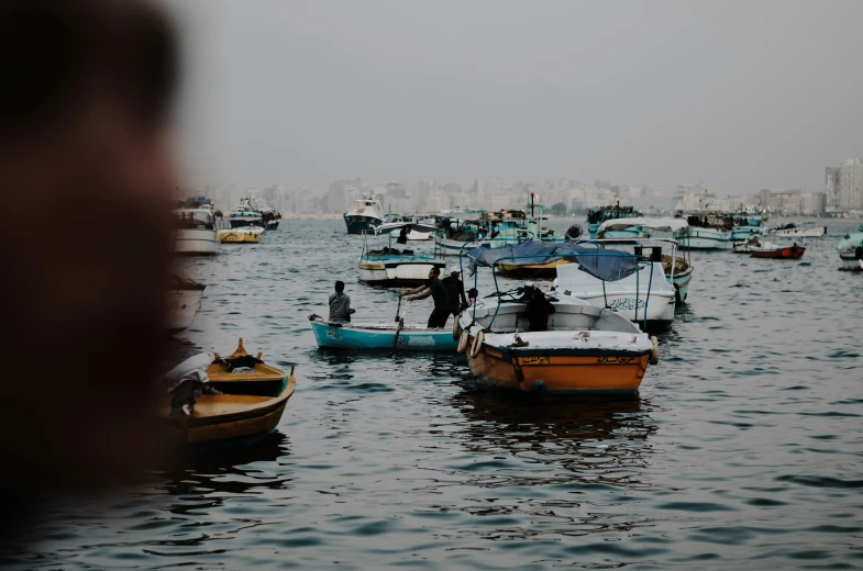 there are boats out in the water near a city