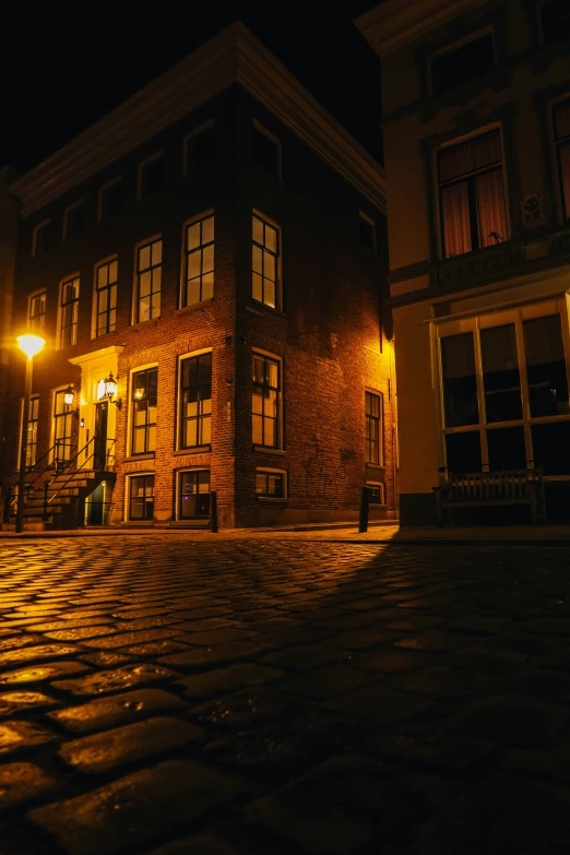 a building with an illuminated street lamp on the side