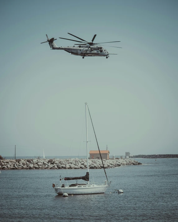 two planes flying above a small boat in the water