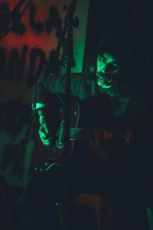 a guy with scary makeup playing a guitar