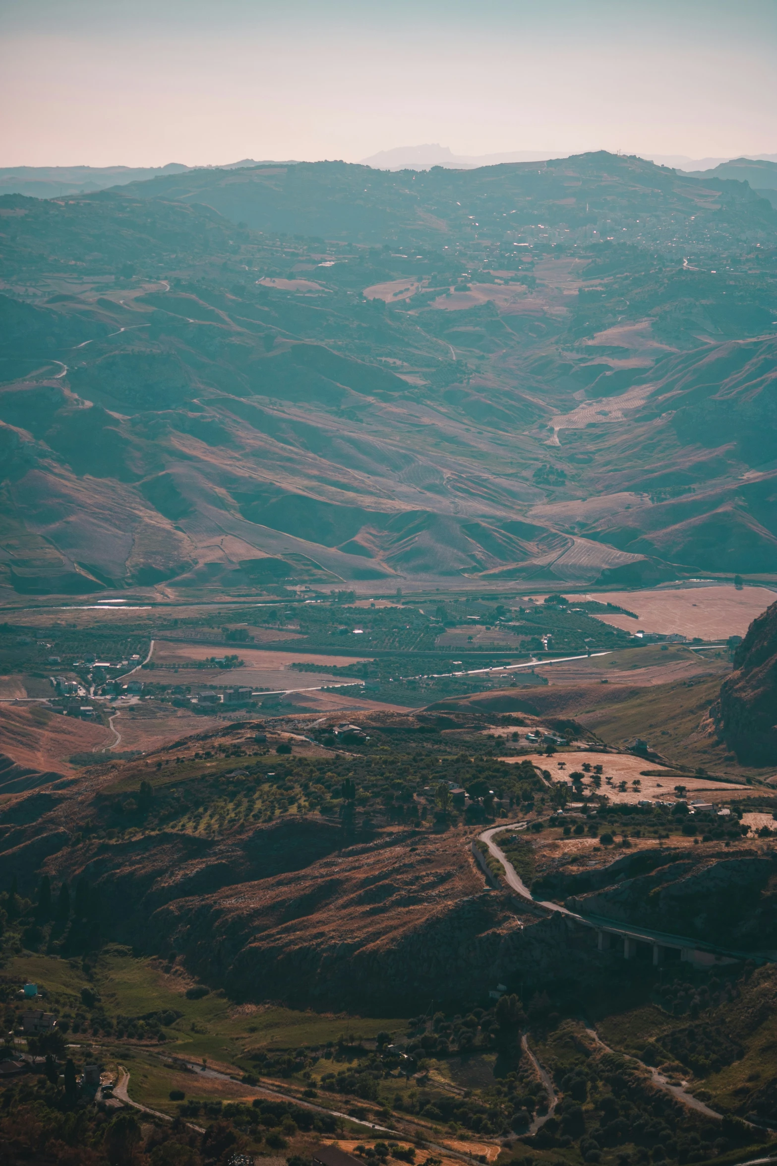 an old road is running between some hills