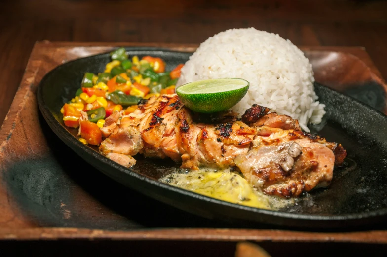 a large plate topped with chicken, rice and vegetables