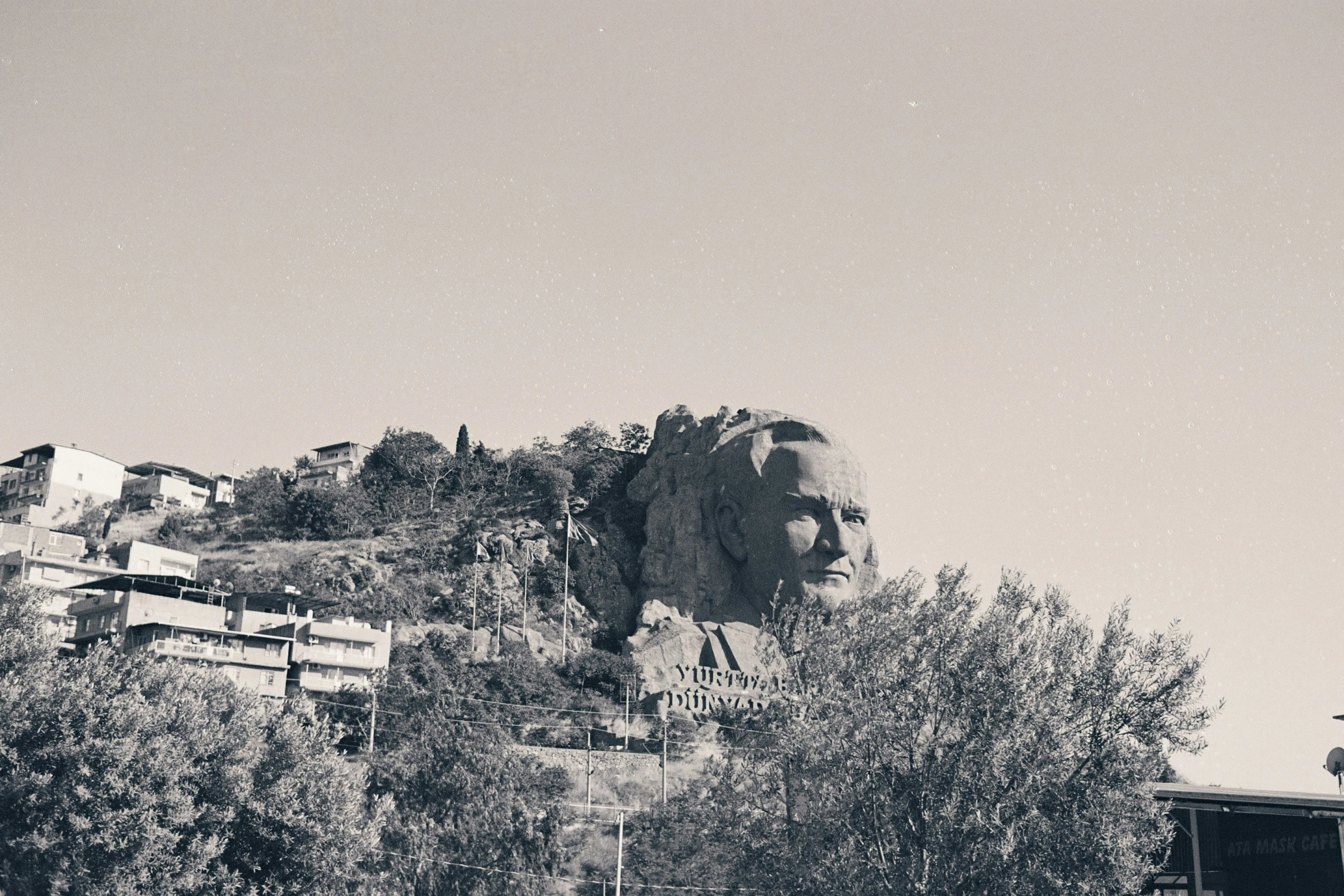 a large elephant head sits above some buildings