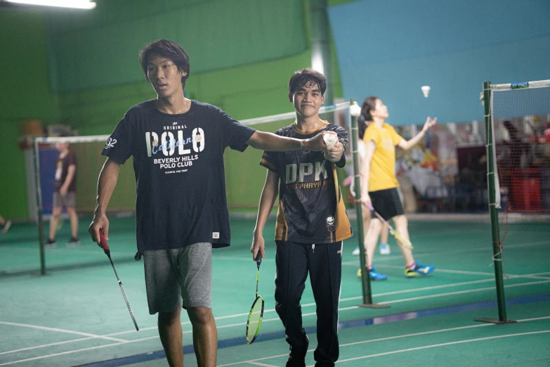 two men holding tennis rackets in each hand