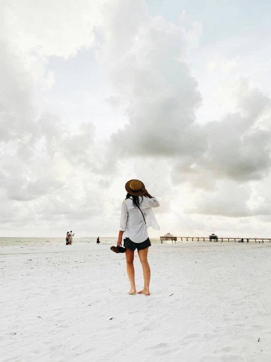 a woman looking at clouds in the sky