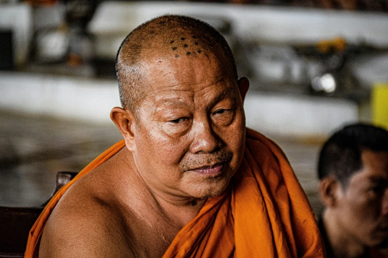 a man with an orange towel around his neck