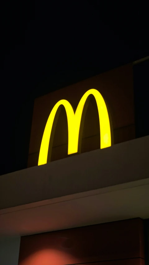 this po has a mcdonald's sign lit up at night