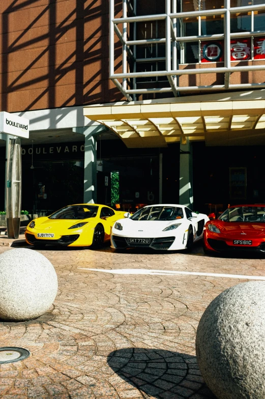 there are some yellow and red sports cars parked near each other