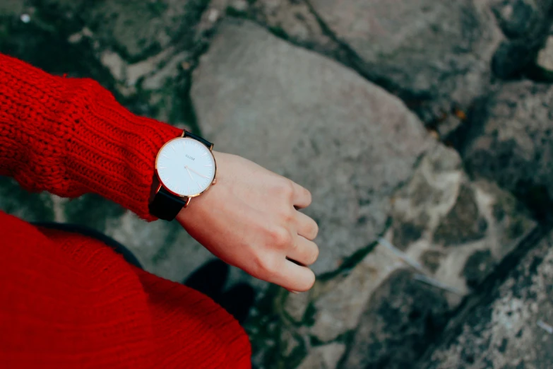 woman's red and black watch on the wrist