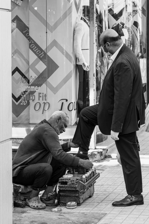 two men with luggage in front of a store