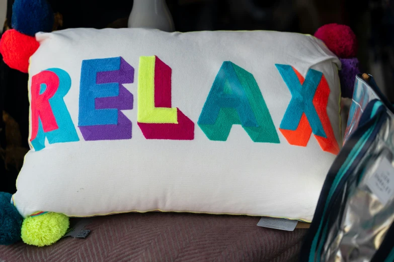 the word relax is painted on a pillow that's attached to a door