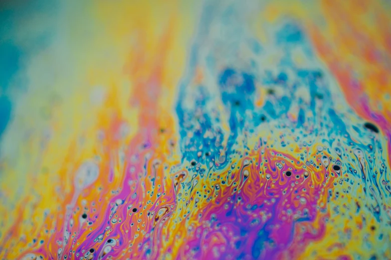 a close up of colorful dye splatches