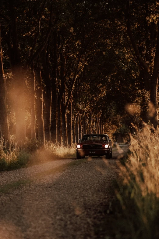 a small car driving down a dirt road