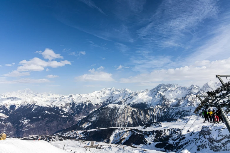 people on a snowy mountain top waiting to go up