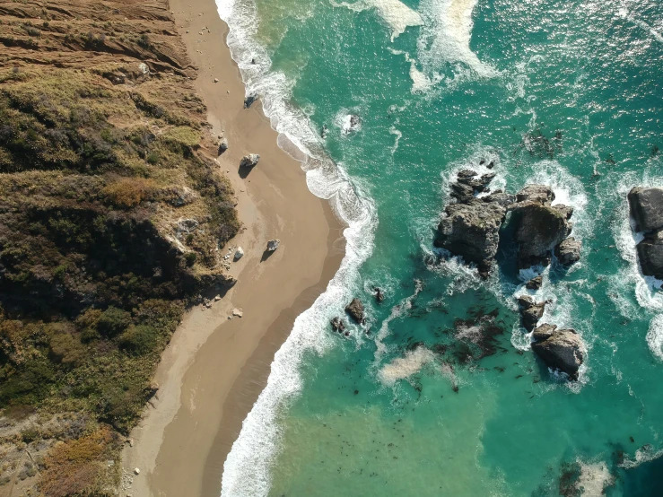 birds eye view of a rocky beach and sandy coastline