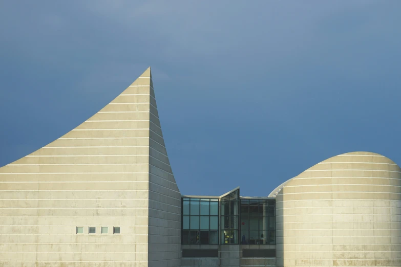 a large white building with a tower near by